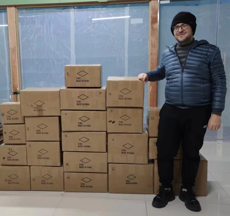 This photo provided by the interviewee shows Oguzhan Arslan from Türkiye checking stocks at a warehouse of his company in north China's Tianjin in 2023. (Xinhua)